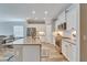 Bright kitchen featuring white cabinets and a large island at 3322 Woodmont Dr, Parrish, FL 34219