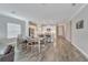 Modern kitchen with white cabinets, island, and spacious dining area at 3322 Woodmont Dr, Parrish, FL 34219