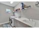 Laundry room with washer, dryer, and shelving at 3322 Woodmont Dr, Parrish, FL 34219