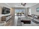 Living room with L-shaped sectional, tile floors, and view of the pool and patio at 3322 Woodmont Dr, Parrish, FL 34219