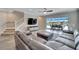 Spacious living area with L-shaped sectional, tile floors, and access to a relaxing patio at 3322 Woodmont Dr, Parrish, FL 34219