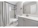 Clean bathroom, featuring a shower/tub combo and gray vanity at 3409 E Comanche Ave, Tampa, FL 33610