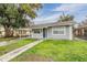 Front view of a freshly painted gray house with a small lawn at 3409 E Comanche Ave, Tampa, FL 33610