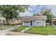 Gray house with blue door, walkway, and grassy yard at 3409 E Comanche Ave, Tampa, FL 33610