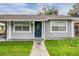 Newly painted gray house with blue front door at 3409 E Comanche Ave, Tampa, FL 33610