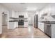 Modern kitchen with white cabinets, granite countertops and stainless steel appliances at 3409 E Comanche Ave, Tampa, FL 33610
