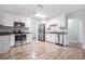 Modern kitchen with white cabinets, granite countertops and stainless steel appliances at 3409 E Comanche Ave, Tampa, FL 33610