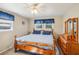 Comfortable bedroom with wood furniture and window coverings at 35138 Dale Ave, Zephyrhills, FL 33541