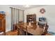 Bright dining room with wood table and chairs, hardwood floors, and decorative accents at 35138 Dale Ave, Zephyrhills, FL 33541