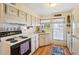 Cozy kitchen featuring wood cabinets and modern appliances at 35138 Dale Ave, Zephyrhills, FL 33541