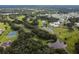 Aerial view showing community near a golf course and lake at 36819 Kiowa Ave, Zephyrhills, FL 33542