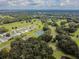 Aerial view of community with tennis courts and lush landscape at 36819 Kiowa Ave, Zephyrhills, FL 33542