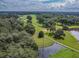 Aerial view of the golf course with water features at 36819 Kiowa Ave, Zephyrhills, FL 33542