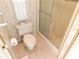 Bathroom features a toilet and shower in a small space at 36819 Kiowa Ave, Zephyrhills, FL 33542