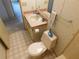 Neat bathroom with toilet, sink, and a decorative accent at 36819 Kiowa Ave, Zephyrhills, FL 33542