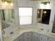 Double vanity bathroom with large mirrors and window at 36819 Kiowa Ave, Zephyrhills, FL 33542