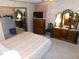 Spacious bedroom with large dresser, TV, and walk-in closet at 36819 Kiowa Ave, Zephyrhills, FL 33542