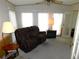 Relaxing Gathering room with a comfortable recliner and large window at 36819 Kiowa Ave, Zephyrhills, FL 33542