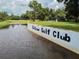 Aerial view of Betmar Golf Club sign by the water at 36819 Kiowa Ave, Zephyrhills, FL 33542