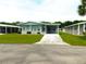 Front view of a light blue single wide home at 36819 Kiowa Ave, Zephyrhills, FL 33542