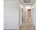 Hallway with wood-look floors and access to bedrooms and bathroom at 380 137Th Avenue Cir, Madeira Beach, FL 33708