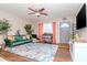 Living room featuring hardwood floors, green sofa, and a ceiling fan at 38214 Jendral Ave, Zephyrhills, FL 33542