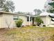 Tan house with a one car garage and small front yard at 4135 Helena Ne St, St Petersburg, FL 33703