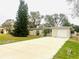 House exterior featuring a large tree and a long driveway at 4135 Helena Ne St, St Petersburg, FL 33703