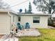Small patio area with two blue chairs at 4135 Helena Ne St, St Petersburg, FL 33703
