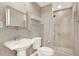 Clean bathroom with walk-in shower, toilet, and pedestal sink at 450 Knights Run Ave # 605, Tampa, FL 33602