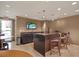 Community kitchen and bar area with seating and large TV at 450 Knights Run Ave # 605, Tampa, FL 33602