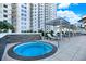 Circular hot tub with lounge chairs on patio with building view at 450 Knights Run Ave # 605, Tampa, FL 33602
