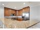 U-shaped kitchen with granite countertops and wood cabinets at 450 Knights Run Ave # 605, Tampa, FL 33602