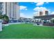 Artificial turf lawn area with seating and building view at 450 Knights Run Ave # 605, Tampa, FL 33602