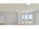 Spacious living room featuring hardwood floors and access to a private balcony with city views at 450 Knights Run Ave # 605, Tampa, FL 33602