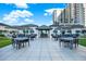 Outdoor patio area with tables, chairs, and grilling station at 450 Knights Run Ave # 605, Tampa, FL 33602