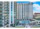 Resort-style pool with lounge chairs and green landscaping at 450 Knights Run Ave # 605, Tampa, FL 33602