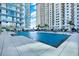 Resort-style pool with surrounding lounge chairs and building view at 450 Knights Run Ave # 605, Tampa, FL 33602