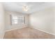 Simple bedroom with neutral walls, carpet flooring, and a window at 4746 Azalea Dr # 203C, New Port Richey, FL 34652