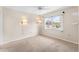 Bright bedroom with neutral walls, carpet flooring, and a window with natural light at 4746 Azalea Dr # 203C, New Port Richey, FL 34652