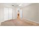 Bedroom with carpet flooring, double door closet, and access to another room at 4746 Azalea Dr # 203C, New Port Richey, FL 34652
