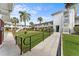 Well-maintained pathway with lush landscaping and access ramp at 4746 Azalea Dr # 203C, New Port Richey, FL 34652