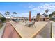 Relaxing outdoor patio area with tables and umbrellas near the pool at 4746 Azalea Dr # 203C, New Port Richey, FL 34652