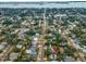 Aerial view showcasing home's location in a residential neighborhood near the water at 546 Orangewood Dr, Dunedin, FL 34698