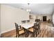 Open concept dining room with hardwood floors and living room view at 546 Orangewood Dr, Dunedin, FL 34698