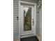 White front door with elegant beveled glass accents at 546 Orangewood Dr, Dunedin, FL 34698