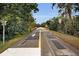 Paved road with pedestrian crossing and signage at 546 Orangewood Dr, Dunedin, FL 34698