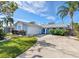 Curved driveway leading to light blue house with two-car garage at 5630 Venetian Ne Blvd, St Petersburg, FL 33703