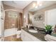 Elegant bathroom featuring granite countertops and a soaking tub at 5701 S Macdill Ave, Tampa, FL 33611