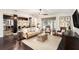 Spacious living room with dark hardwood floors, comfortable seating, and access to a patio at 5701 S Macdill Ave, Tampa, FL 33611